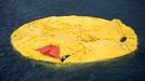 Hong Kong Rubber Duck 2013-05-15 00:00:00 epa03700686 Dutch conceptual artist Florentijn Hofman's 'Rubber Duck' floats, deflated and flattened on Victoria Harbour, Hong Kong, China, 15 May 2013. It is not immediately known why the duck, scheduled to float outside Ocean Terminal inTsim Sha Tsui until 09 June deflated. EPA/JEROME FAVRE