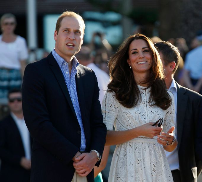 Britain's Prince William and his wife Catherine, the Duchess of Cambridge, stand next to each other during their visit to a surf lifesaving demonstration at Sydney's Manl