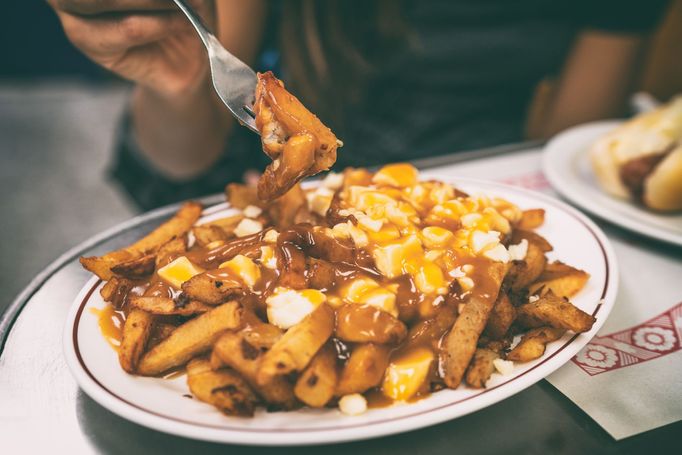 Hranolky, kousky mladého sýra a hustá hnědá omáčka. To je kanadské poutine.