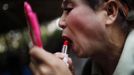 Xiao Cao, a 57-year-old gay man, puts on makeup before his performance at a park in Shanghai April 8, 2012. China's gay community has long been on the edges of society but it is gradually becoming more accepted. Cao, who is an unemployed drag queen, is one whose life lifts the curtain on a less romanticised view of Chinese homosexuals. Living in an eight-square-metre apartment behind a public toilet and with a monthly income of 500 yuan ($79) from social insurance, he passes his days dancing in public and spending time with friends at gay clubs. Picture taken April 8, 2012. REUTERS/Aly Song (CHINA - Tags: SOCIETY) CHINA OUT. NO COMMERCIAL OR EDITORIAL SALES IN CHINA. ATTENTION EDITORS PICTURE 09 OF 28 OF PACKAGE 'GAY AND OUT IN CHINA' TO FIND ALL IMAGES SEARCH 'GAY OUT CHINA' Published: Čer. 1, 2012, 12:36 dop.