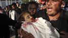 A relative carries the body of 2-year-old Palestinian Waleed Al-Abadlah during his funeral in the southern Gaza Strip city of Khan Younis on Thursday, Nov. 15, 2012. According to the family, Al-Abadlah died from wounds sustained in an Israeli air strike near his home. Palestinian militants hit Israel with nearly 150 rockets on Thursday, as Israel continued a campaign of airstrikes on militant targets across the Gaza Strip. (AP Photo/Hatem Omar)