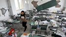 Chen Liujun carries books out of her classroom after Saturday's earthquake hit Lushan county, Ya'an, Sichuan province, April 22, 2013. Chen and her fellow third-year high school students in Lushan were transferred to Chengdu to complete their high school education and prepare for the coming college entrance exams in the provincial capital, reported local news. Hundreds of survivors of an earthquake that killed nearly 200 people in southwest China pushed into traffic on a main road on Monday, waving protest signs, demanding help and shouting at police. Picture take April 22, 2013. REUTERS/Stringer (CHINADISASTER - Tags: DISASTER EDUCATION) CHINA OUT. NO COMMERCIAL OR EDITORIAL SALES IN CHINA Published: Dub. 23, 2013, 5:09 dop.