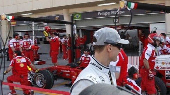 Michael Schumacher se prochází kolem stáje Ferrari