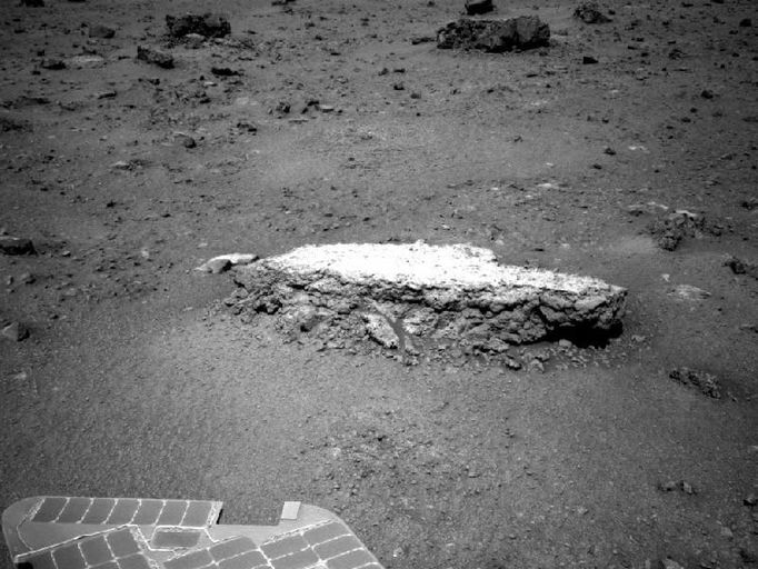 Approaching 'Tisdale 2' Rock on Rim of Endeavour Crater NASA's Mars Exploration Rover Opportunity used its navigation camera to take this picture showing a light-toned rock, "Tisdale 2," during the 2,690th Martian day, or sol, of the rover's work on Mars (Aug. 18, 2011). The rock is about 12 inches (30 centimeters) tall. In subsequent sols, the rover used tools on its robotic arm to examine Tisdale 2. That rock and others on the ground beyond it were apparently ejected by the impact that excavated a 66-foot-wide (20-meter-wide) crater, called "Odyssey," which is nearby to the left (north) of this scene. Odyssey and these rocks are on a low ridge called "Cape York," which is a segment of the western rim of Endeavour crater. Part of Opportunity's array of photovoltaic cells is visible in the foreground. Image Credit: NASA/JPL-Caltech