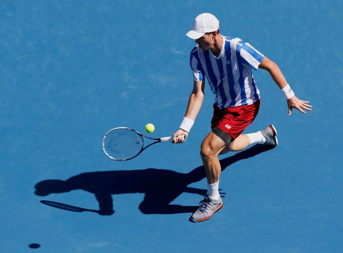 Tomas Berdych of the Czech Republic hits a return to Damir Dzumhur of Bosnia and Herzegovina during their men's singles match at the Australian Open 2014 tennis tournamen