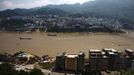 Ships sail on the Yangtze River in Badong, 100km (62 miles) from the Three Gorges dam in Hubei province August 7, 2012. China relocated 1.3 million people during the 17 years it took to complete the Three Gorges dam. Even after finishing the $59 billion project last month, the threat of landslides along the dam's banks will force tens of thousands to move again. It's a reminder of the social and environmental challenges that have dogged the world's largest hydroelectric project. While there has been little protest among residents who will be relocated a second time, the environmental fallout over other big investments in China has become a hot-button issue ahead of a leadership transition this year. Picture taken on August 7, 2012. To match story CHINA-THREEGORGES/ REUTERS/Carlos Barria (CHINA - Tags: POLITICS ENVIRONMENT BUSINESS ENERGY MARITIME) Published: Srp. 22, 2012, 8:23 odp.