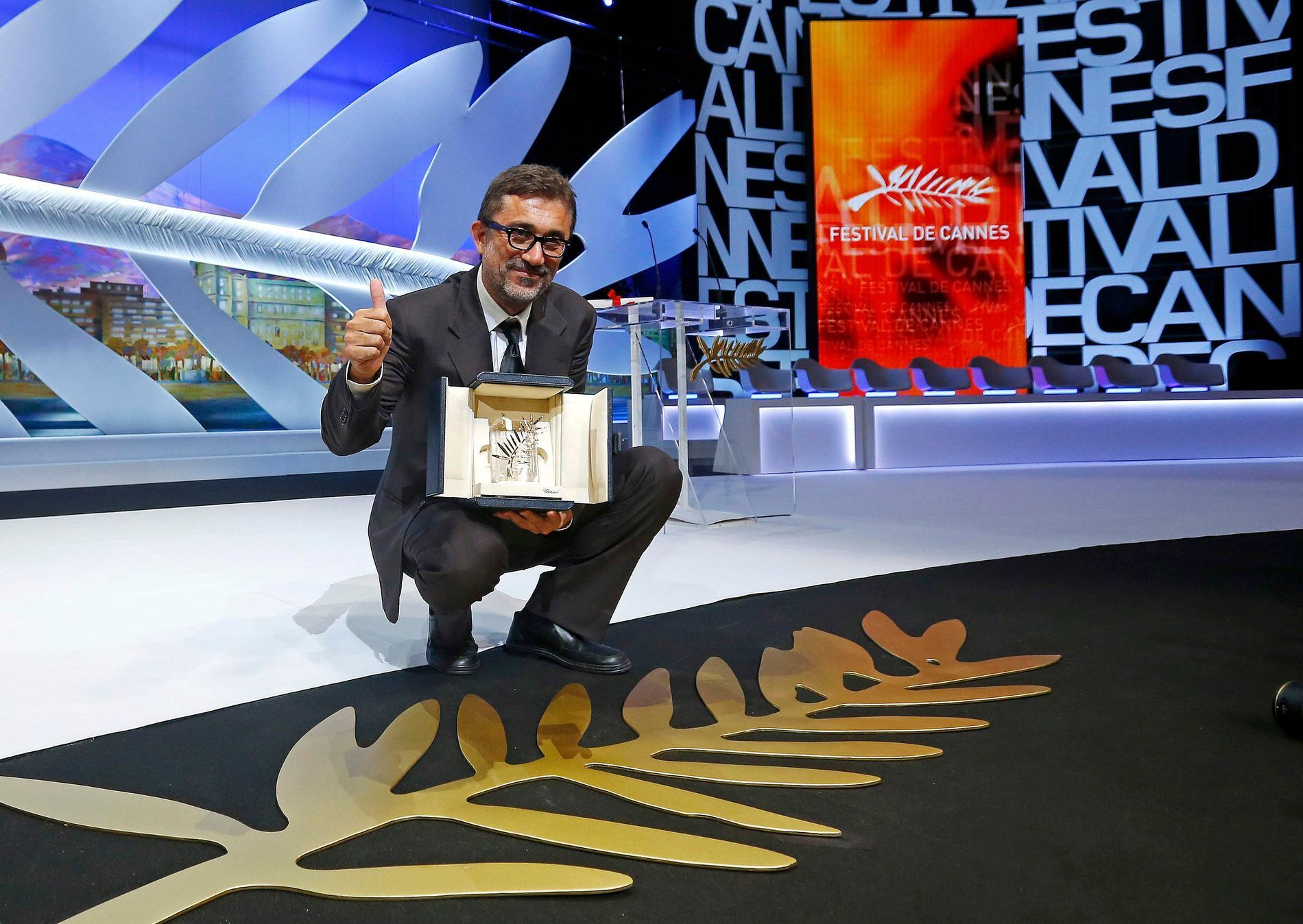 Director Nuri Bilge Ceylan, Palme d'Or award winner for his film &quot;Winter Sleep&quot;, poses on stage during the closing ceremony of the 67th Cannes Film Festival in Cannes