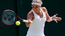 Sabine Lisicki of Germany hits a shot during her match against Timea Bacsinszky of Switzerland at the Wimbledon Tennis Championships in London