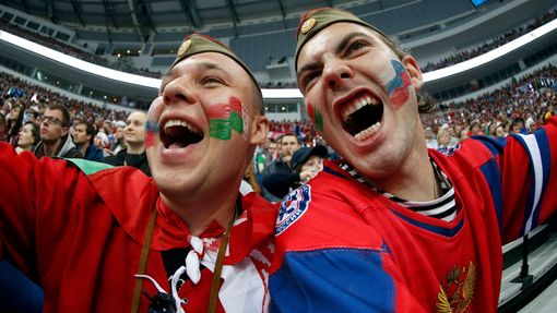 Two supporters of Russia cheer their team during the first period of their men's ice hockey World Championship Group B game against Belarus at Minsk Arena in Minsk May 20