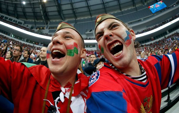 Two supporters of Russia cheer their team during the first period of their men's ice hockey World Championship Group B game against Belarus at Minsk Arena in Minsk May 20