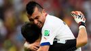 Chile's Gary Medel (R) hugs teammate Claudio Bravo after Chile's Eduardo Vargas scored the team's first goal during their 2014 World Cup Group B soccer match at the Marac