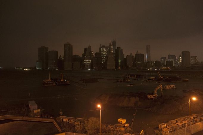 The skyline of lower Manhattan sits in darkness after a preventive power outage in New York October 29, 2012. Hurricane Sandy could be the biggest storm to hit the United States mainland when it comes ashore on Monday night, bringing strong winds and dangerous flooding to the East Coast from the mid-Atlantic states to New England, forecasters said on Sunday. REUTERS/Keith Bedford (UNITED STATES - Tags: ENVIRONMENT CITYSPACE DISASTER) Published: Říj. 30, 2012, 2:15 dop.