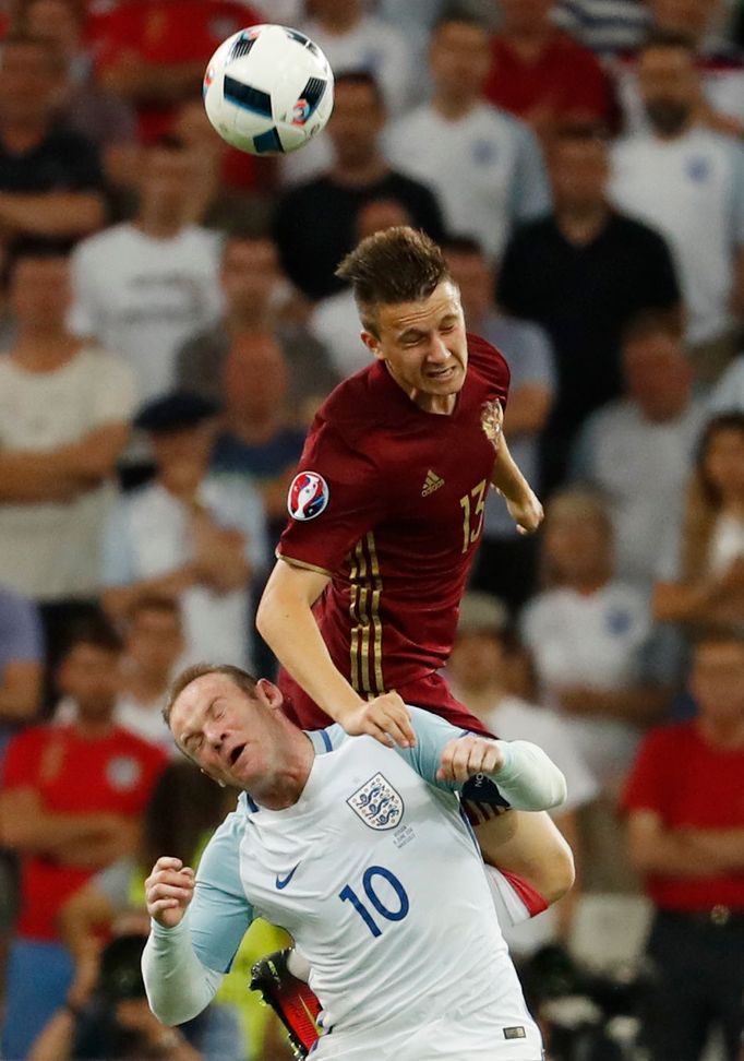 Russia's Aleksandr Golovin in action with England's Wayne Rooney