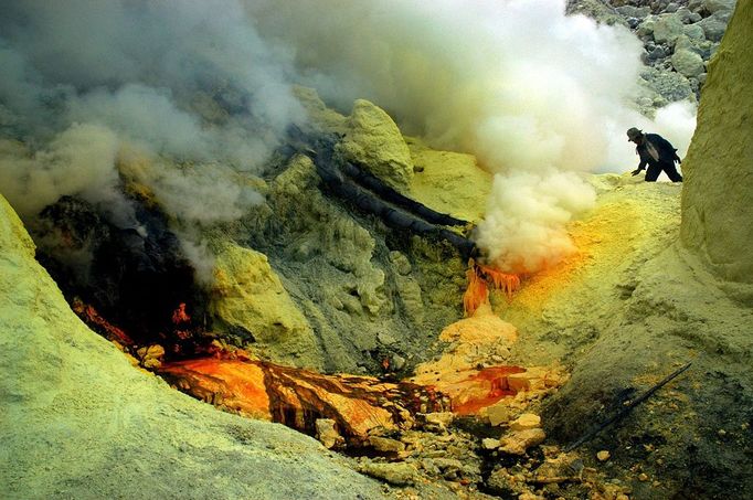 Sulfur Miners Of Ijen Crater Indonesia BANYUWANGI, INDONESIA - UNDATED: A miner digs sulfur at a mine in the crater of Ijen, Banyuwangi, Indonesia. Sulphur miners at the