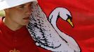 A flag wraps around one of the Queen's Swan Uppers during the annual Swan Upping ceremony on the River Thames between Shepperton and Windsor in southern England July 15,