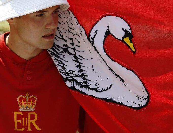 A flag wraps around one of the Queen's Swan Uppers during the annual Swan Upping ceremony on the River Thames between Shepperton and Windsor in southern England July 15,