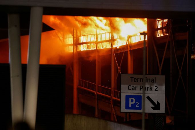 Flames are seen as emergency services respond to a fire in Terminal Car Park 2 at London Luton airport in Luton, Britain, October 11, 2023.  REUTERS/Peter Cziborra