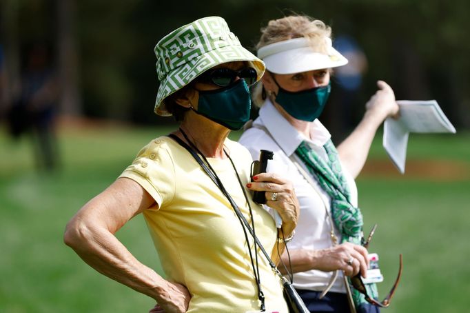 Golf - The Masters - Augusta National Golf Club - Augusta, Georgia, U.S. - November 12, 2020 Spectator wearing a protective face mask watches on during the first round RE