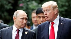 FILE PHOTO: U.S. President Donald Trump and Russia's President Vladimir Putin talk during the family photo session at the APEC Summit in Danang, Vietnam