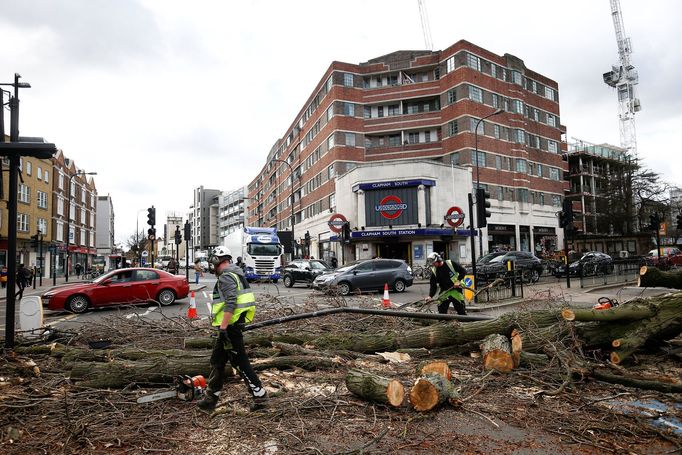 Workers remove a tree lying across a road after it was blown over by high winds, in London, Britain March 10,  2019. REUTERS/Henry Nicholls