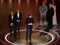 Producent James Wilson, obchodník Leonard Blavatnik a režisér Jonathan Glazer přebírají Oscara za film Zóna zájmu.