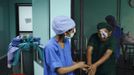 A patient is helped by a nurse after undergoing a surgery to remove his cataract at the Tilganga Eye Center in Kathmandu April 25, 2012. About 150,000 of Nepal's 26.6 million people are estimated to be blind in both eyes, most of them with cataracts. Picture taken April 25, 2012. REUTERS/Navesh Chitrakar (NEPAL - Tags: HEALTH SOCIETY POVERTY) Published: Kvě. 2, 2012, 4:38 dop.