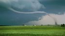 Wizard of OZ like rope tornado sweeps across fields of green wheat in the panhandle of Texas near Rope tornado over green wheat field with old farm houses in the distance, Texas USA North America. Keywords Willett and Tornado to see all of my tornado images or keyword Lightningsmiths to see all of my severe weather images.