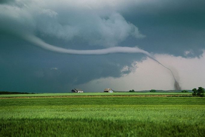 Wizard of OZ like rope tornado sweeps across fields of green wheat in the panhandle of Texas near Rope tornado over green wheat field with old farm houses in the distance, Texas USA North America. Keywords Willett and Tornado to see all of my tornado images or keyword Lightningsmiths to see all of my severe weather images.