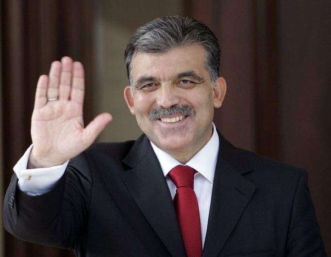 President-elect Abdullah Gul waves after he received his official election document in Ankara August 28, 2007. Gul, a a respected former Islamist, won a third round of voting in parliament on Tuesday to become Turkey's next president, a ruling AK Party deputy told Reuters. Gul's first bid in April was blocked by the secular elite, which includes army generals, sparking a political crisis and ultimately triggering early parliamentary elections. REUTERS/Umit Bektas (TURKEY)