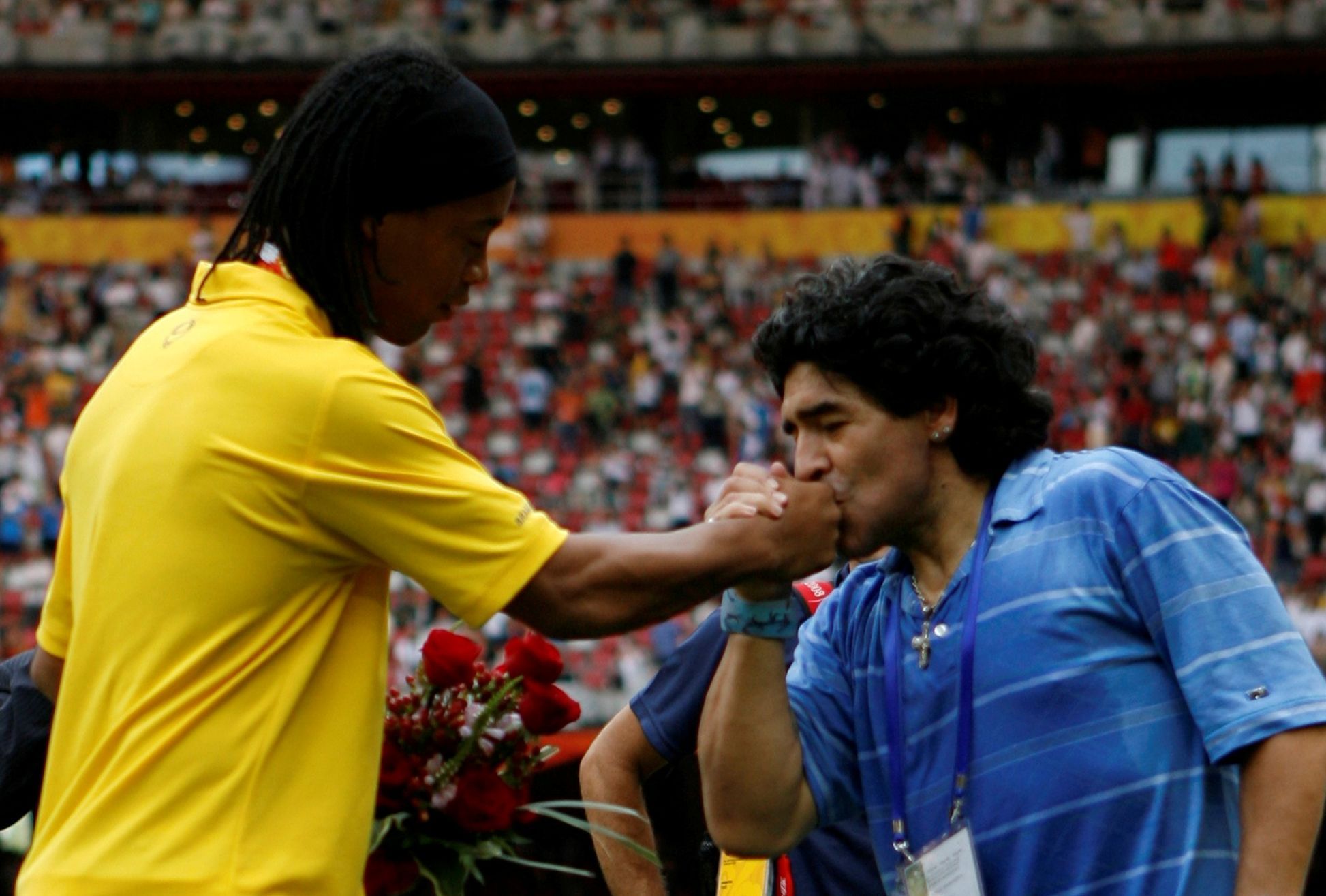 FILE PHOTO: Former Argentine soccer player Diego Maradona kisses the hand of Ronaldinho of Brazil after the medal ceremony for men's soccer at the Beijing 2008 Olympic Games