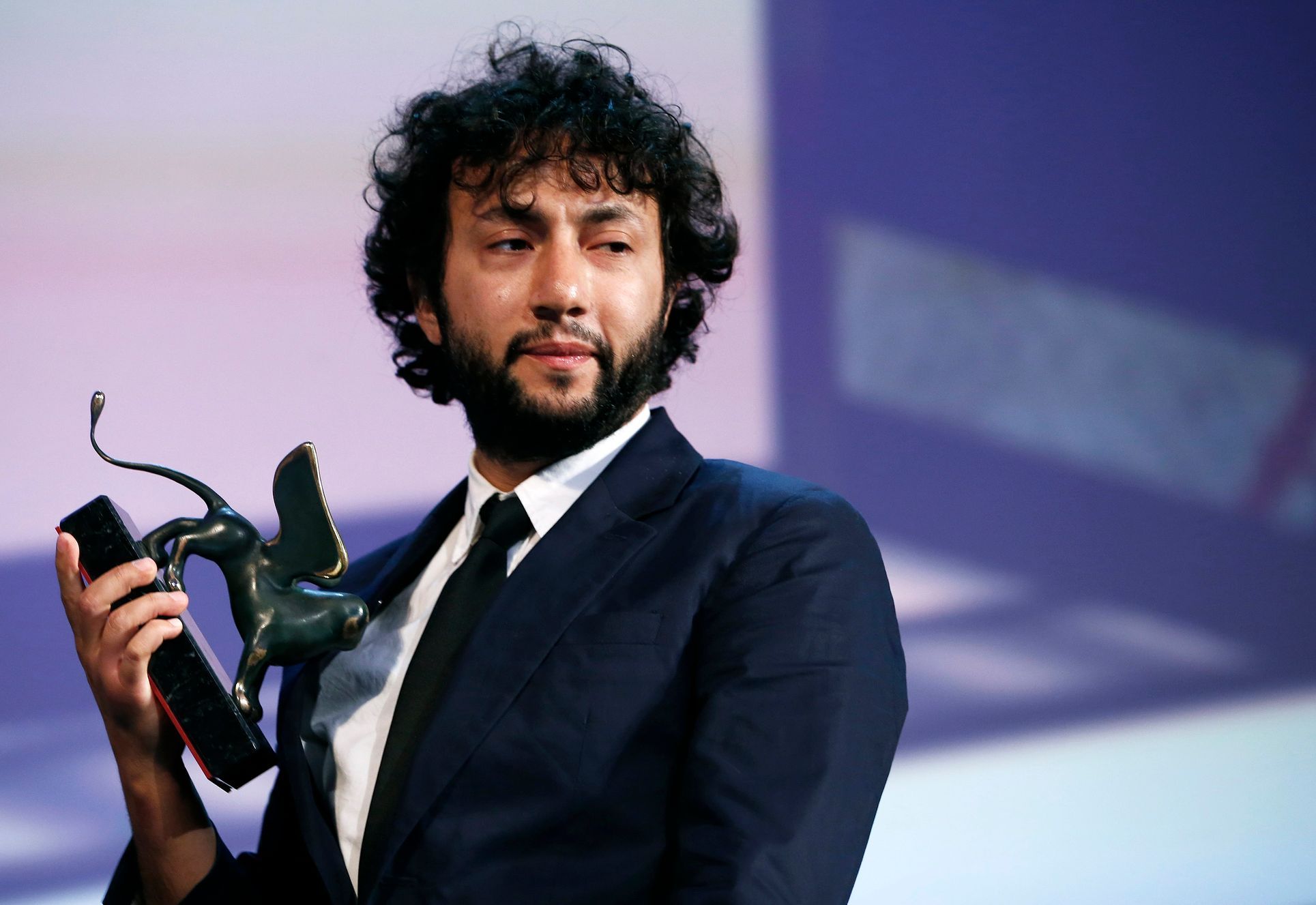 Turkish director Kaan Mujdeci holds the Special Lion prize for his movie &quot;Sivas&quot; during the awards ceremony at the 71st Venice Film Festival