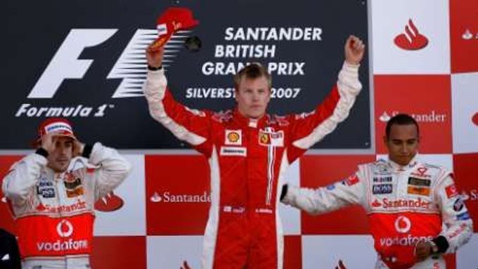 Vítěz Velké ceny Británie Fin Kimi Räikönnen (uprostřed) oslavuje prvenství ve společnosti Fernanda Alonsa (vlevo) a Lewise Hamiltona.