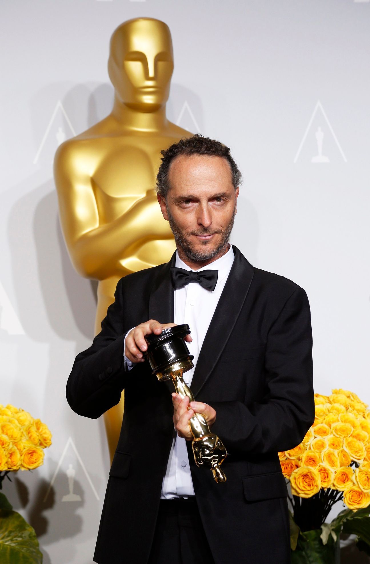 Emmanuel Lubezki poses with his award for best cinematography for his film &quot;Gravity&quot; at the 86th Academy Awards in Hollywood, California