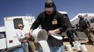 Workers prepare buckets of aluminum oxide mixed with ammonium nitrate to use for targets during the Big Sandy Shoot in Mohave County, Arizona March 23, 2013. The Big Sandy Shoot is the largest organized machine gun shoot in the United States attended by shooters from around the country. Vintage and replica style machine guns and cannons are some of the weapons displayed during the event. REUTERS/Joshua Lott (UNITED STATES - Tags: SOCIETY) Published: Bře. 25, 2013, 3:35 odp.