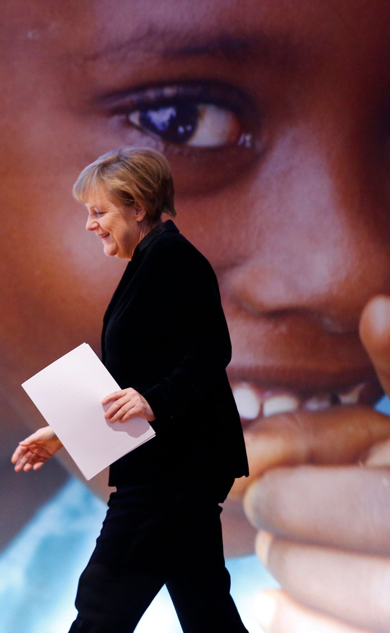 German Chancellor Merkel walks on the stage to address the audience of the Global Alliance for Vaccines and Immunisation (GAVI) conference in Berlin