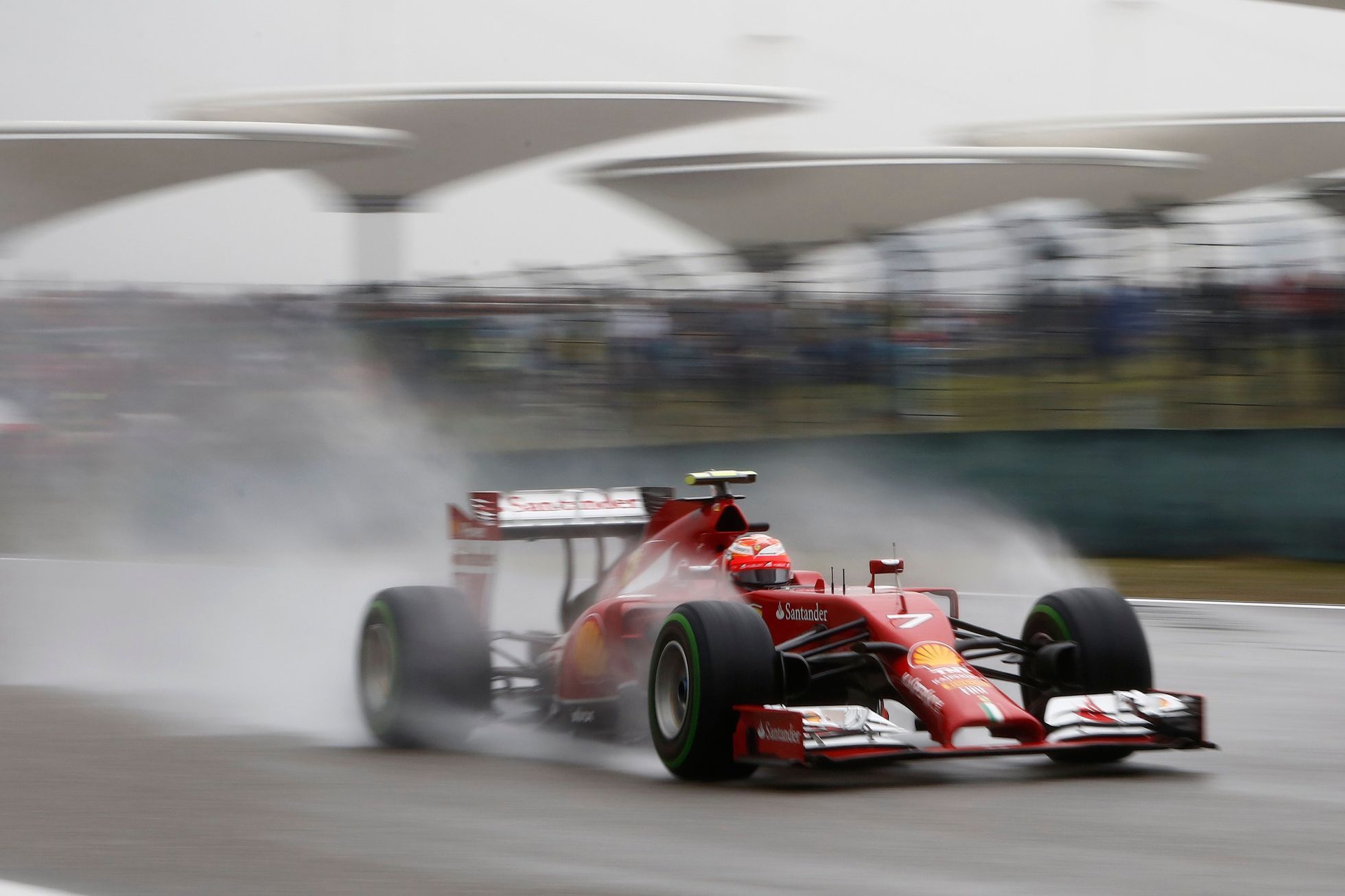 Ferrari Formula One driver Raikkonen of Finland drives during the qualifying session for the Chinese F1 Grand Prix at the Shanghai International circuit