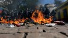 Riot policemen stand behind burning rubbish during a protest against the 2014 World Cup in Sao Paulo June 12, 2014. REUTERS/Ricardo Moraes (BRAZIL - Tags: SPORT SOCCER WO