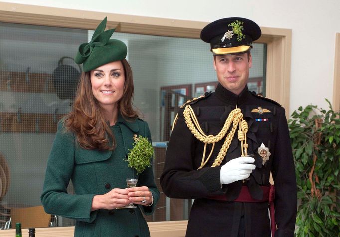 Britain's Prince William and his wife Catherine, Duchess of Cambridge hold their drinks during a visit to the 1st Battalion Irish Guards for a St Patrick's Day Parade at