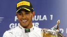 Mercedes Formula One driver Lewis Hamilton of Britain holds his trophy after winning the Bahrain F1 Grand Prix at the Bahrain International Circuit (BIC) in Sakhir, south