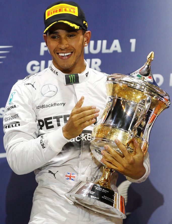 Mercedes Formula One driver Lewis Hamilton of Britain holds his trophy after winning the Bahrain F1 Grand Prix at the Bahrain International Circuit (BIC) in Sakhir, south