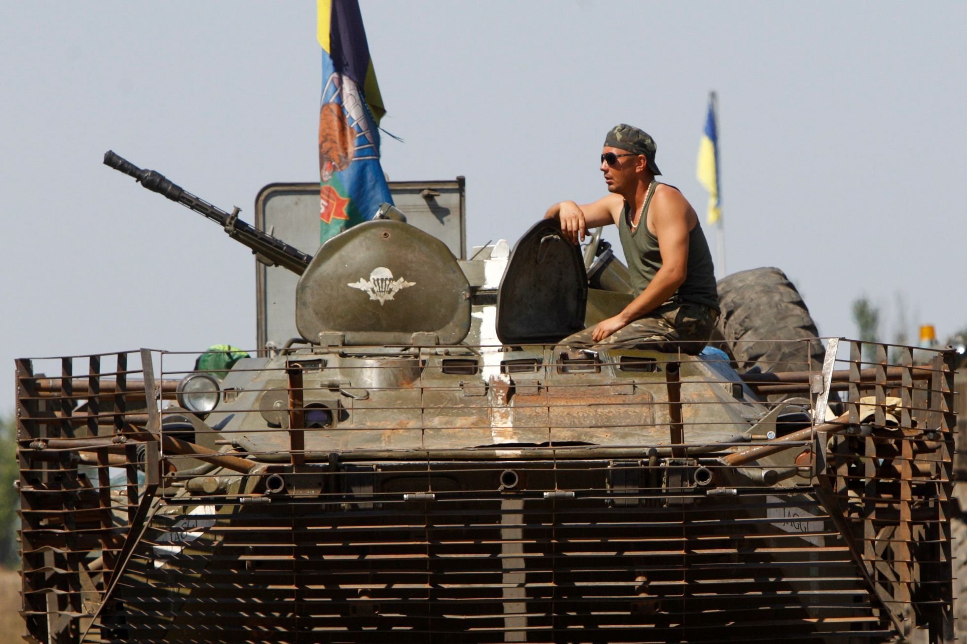 A Ukrainian serviceman sits on a military armoured vehicle near Donetsk