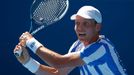 Tomas Berdych of Czech Republic hits a return to Damir Dzumhur of Bosnia and Herzegovina during their men's singles match at the Australian Open 2014 tennis tournament in