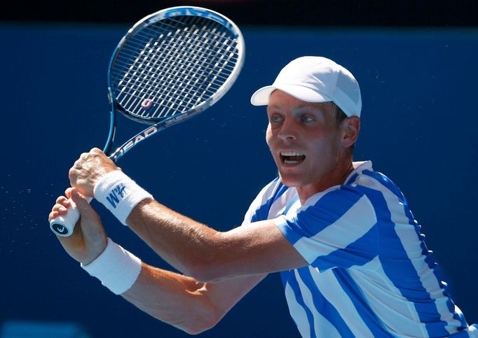 Tomas Berdych of Czech Republic hits a return to Damir Dzumhur of Bosnia and Herzegovina during their men's singles match at the Australian Open 2014 tennis tournament in