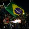 Demonstrators burn a Brazilian flag during a protest against the 2014 World Cup in Rio de Janeiro