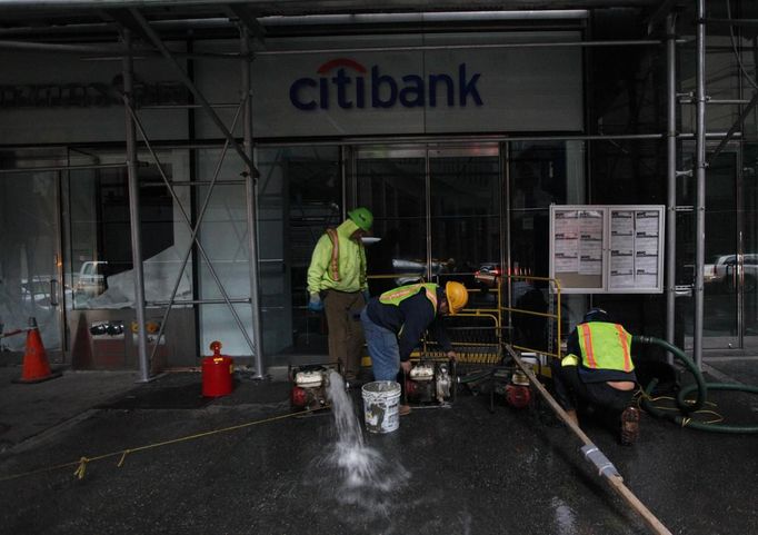 Pracovníci v New Yorku odčerpávají vodu ze zatopených prostor pobočky Citibank.