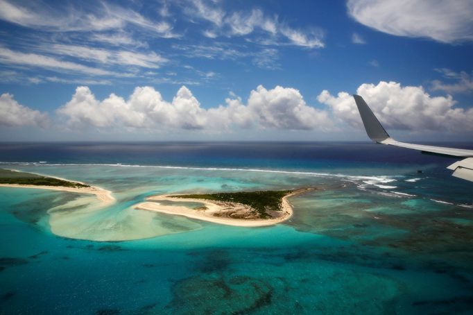 The wing tip of Air Force One can be seen as Obama lands at Henderson Field to visit the Papahanaumokuakea Marine National Monument, Midway Atoll, U.S.