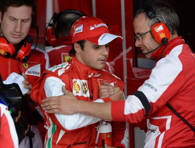 Ferrari Formula One driver Felipe Massa (C) of Brazil reacts after qualifying 12th for the British Grand Prix at the Silverstone Race circuit, central England, June 29, 2