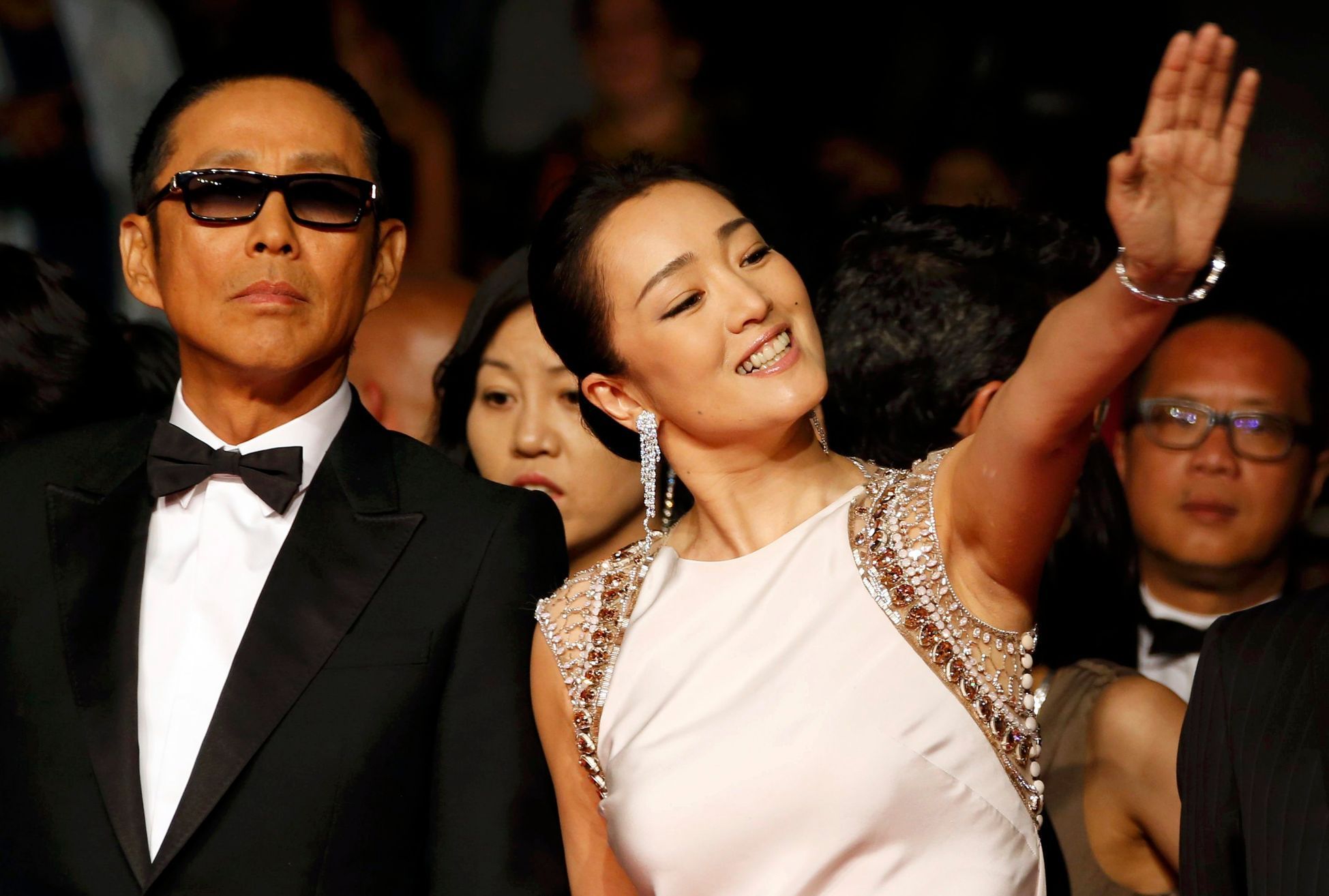 Cast members Gong Li and Chen Daoming pose on the red carpet as they arrive for the screening of the film &quot;Coming Home&quot; out of competition at the 67th Cannes Film Festival in Cannes