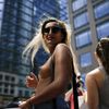 A woman awaits the start of a topless march in New York