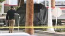 A law enforcement officer walks near the remains of a covered Tesla Cybertruck that burned at the entrance of Trump Tower, in Las Vegas, Nevada, U.S. January 1, 2025.  RE